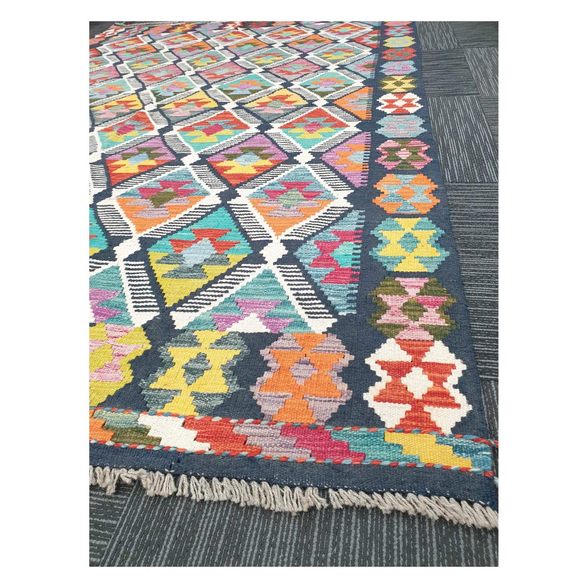 Angled detail of Afghan Chobi Kilim showing fringe, border motifs, and handwoven flatweave texture, 248 x 172 cm