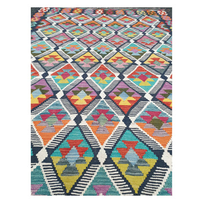 Close-up of Chobi Kilim rug with repeating stepped diamonds in blue, rust, saffron, teal, and ivory, 248 x 172 cm
