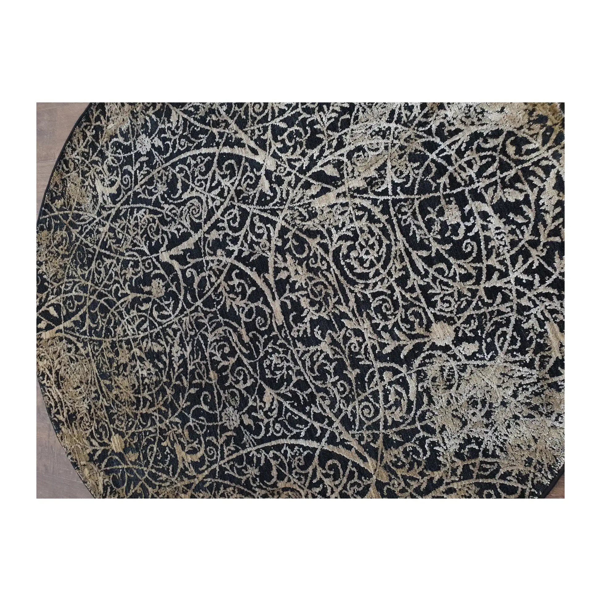Close-up of round rug with navy, beige, and ivory botanical scroll design, 160 cm