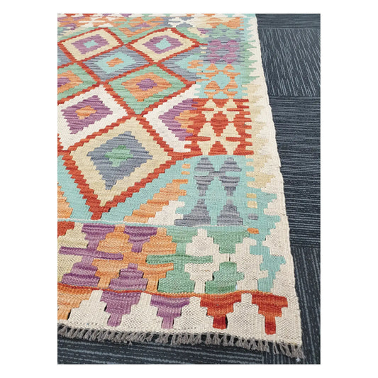 Angled detail of Afghan Chobi Kilim showing fringe, stepped border motifs, and handwoven flatweave texture, 133 x 100 cm