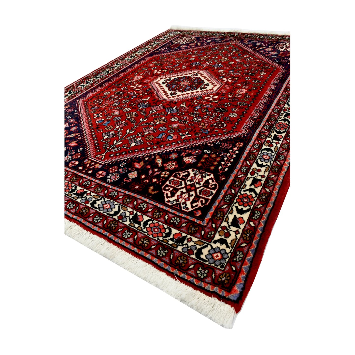 Angled full view of Persian Abadeh hand-knotted wool rug showing the full design, border and central medallion