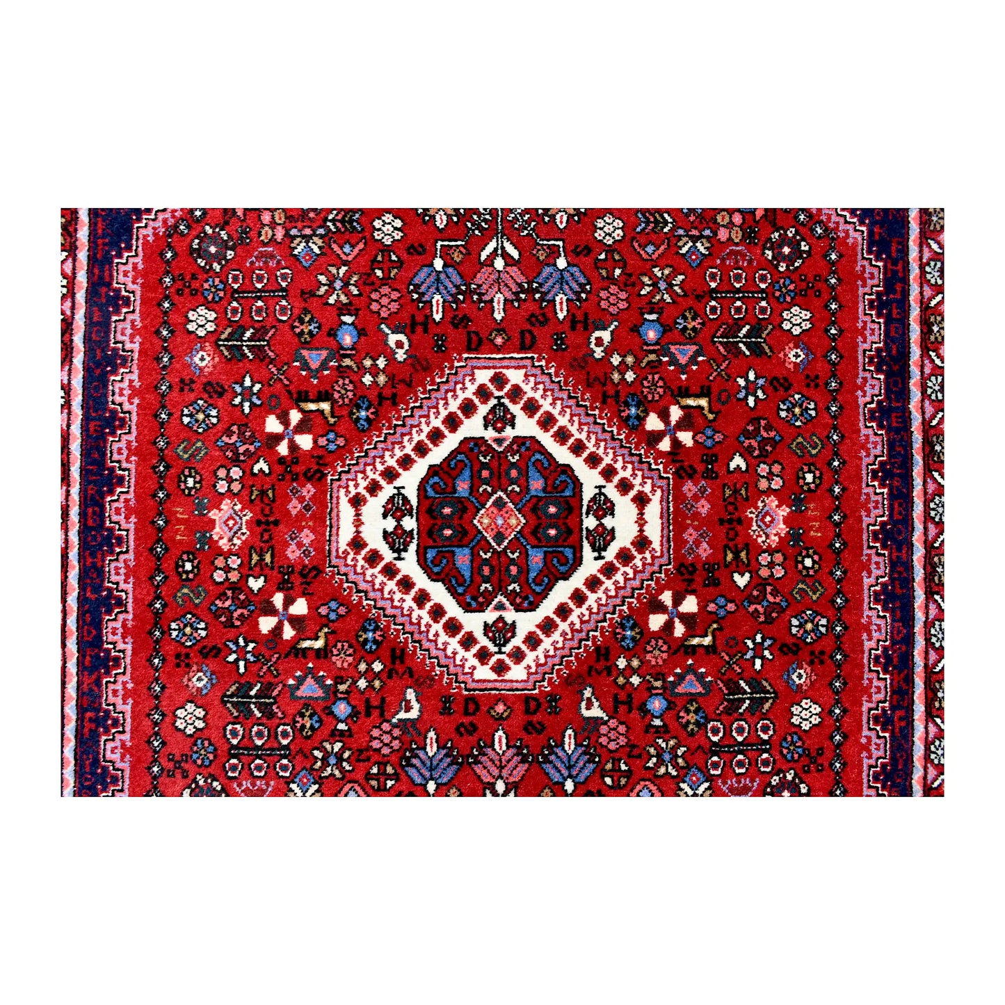 Central medallion detail of Persian Abadeh wool rug showing ivory and navy geometric motifs on a red field
