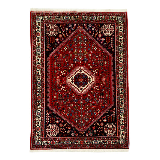 Straightened full view of Persian Abadeh hand-knotted wool rug with red field, bold central medallion and navy corner sections, 150 x 108 cm