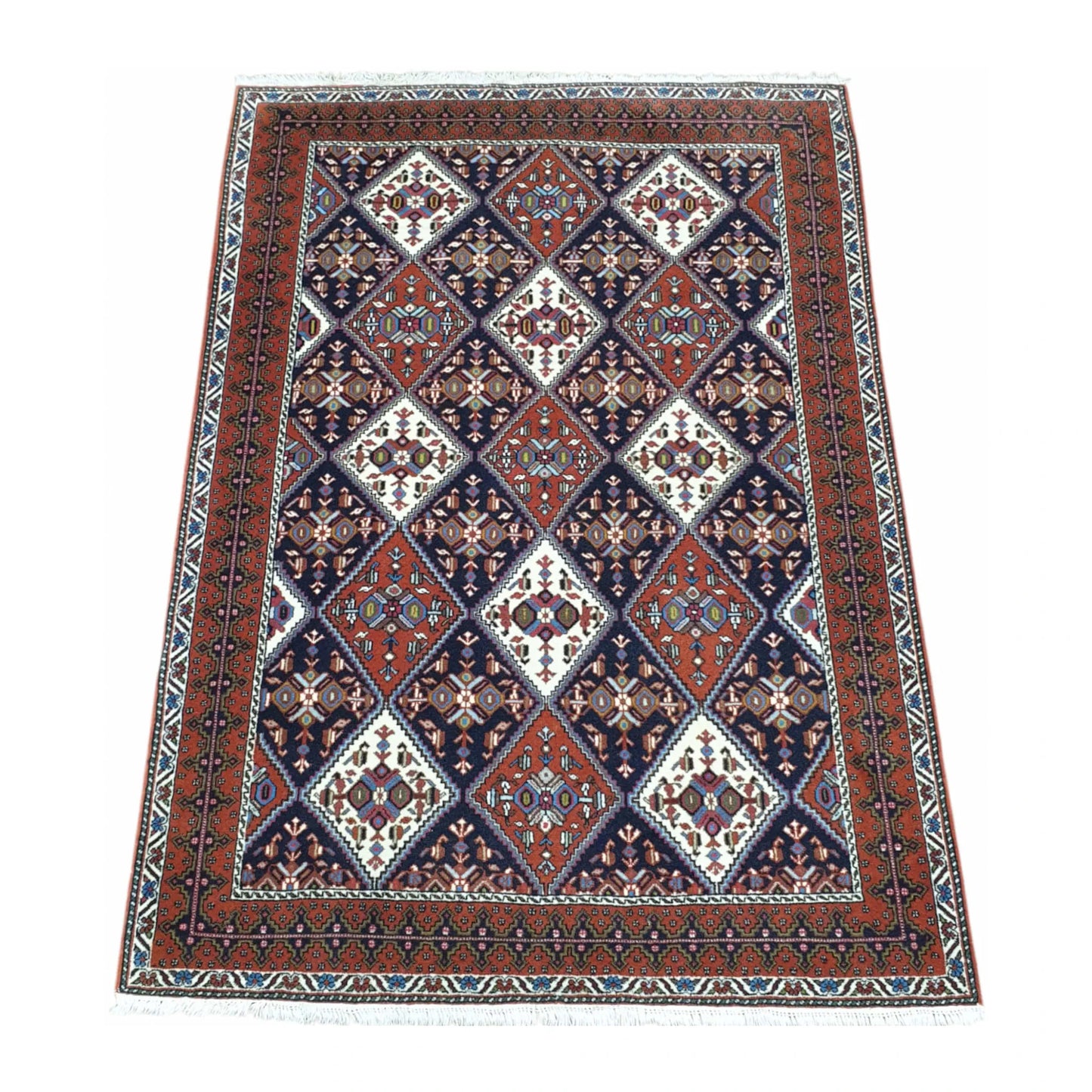Angled full view of Persian Afshar wool rug 180 x 124 cm with tribal geometric pattern and framed border
