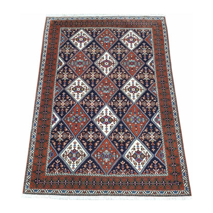 Angled full view of Persian Afshar wool rug 180 x 124 cm with tribal geometric pattern and framed border