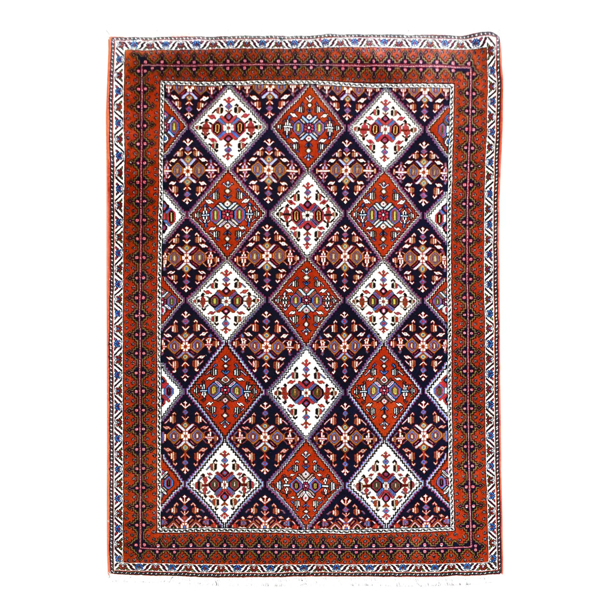 Full view of Persian Afshar hand-knotted wool rug with dark navy diamond lattice and rust-red borders, 180 x 124 cm