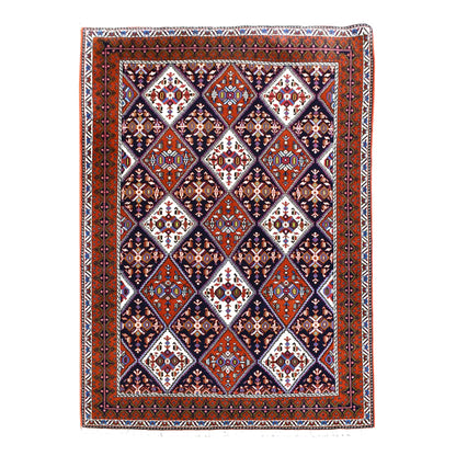 Full view of Persian Afshar hand-knotted wool rug with dark navy diamond lattice and rust-red borders, 180 x 124 cm