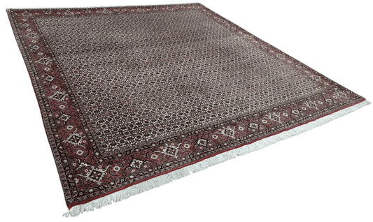Angled view of Persian Bidjar hand-knotted wool rug showing dense wool pile, dark brown field and traditional border, 257 x 250 cm