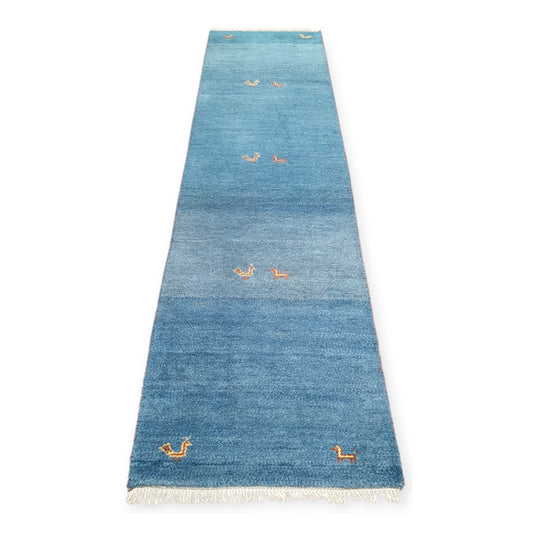 Full view of blue Persian Gabbeh hand-knotted wool runner rug with sparse orange geometric motifs, 300 x 80 cm