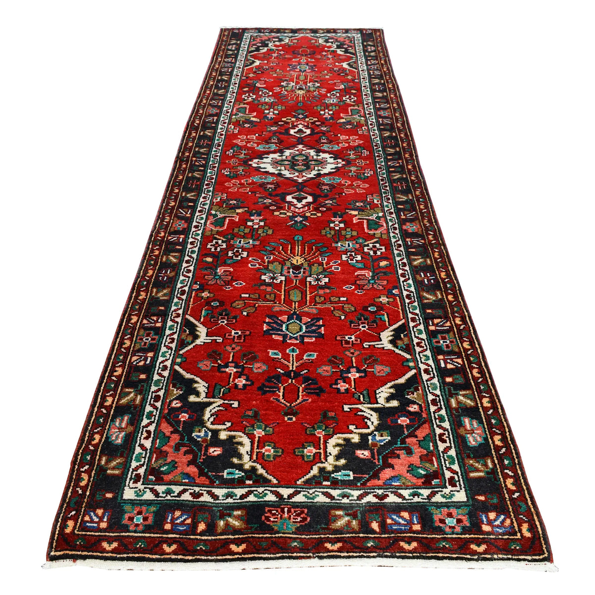 Full view of Persian Hamadan hand-knotted wool runner with floral diamond medallions on a red field, 295 x 86 cm