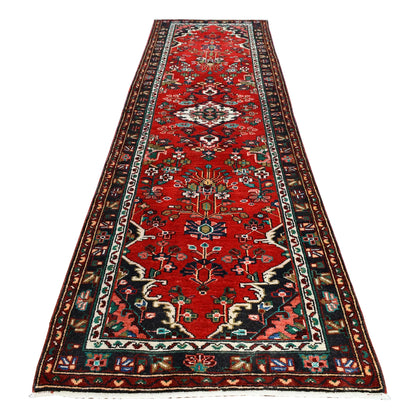Full view of Persian Hamadan hand-knotted wool runner with floral diamond medallions on a red field, 295 x 86 cm