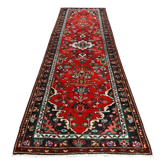 Full view of Persian Hamadan hand-knotted wool runner with floral diamond medallions on a red field, 295 x 86 cm