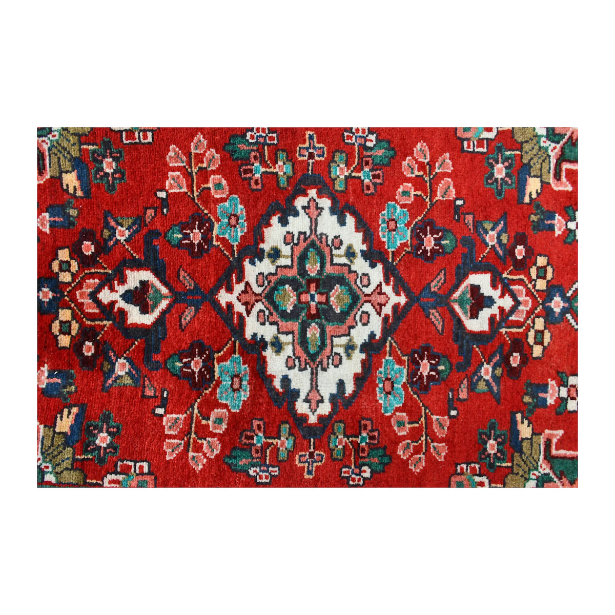 Close-up of Persian Hamadan runner showing an ivory floral diamond medallion with turquoise and green details