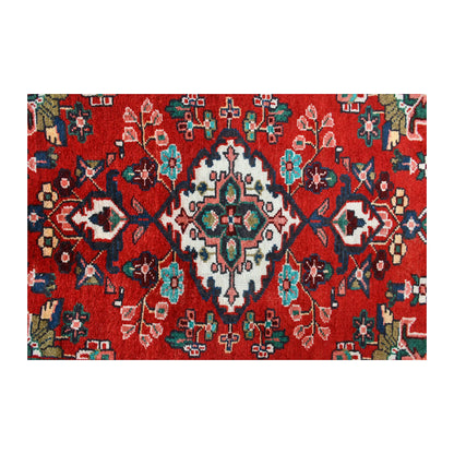 Close-up of Persian Hamadan runner showing an ivory floral diamond medallion with turquoise and green details