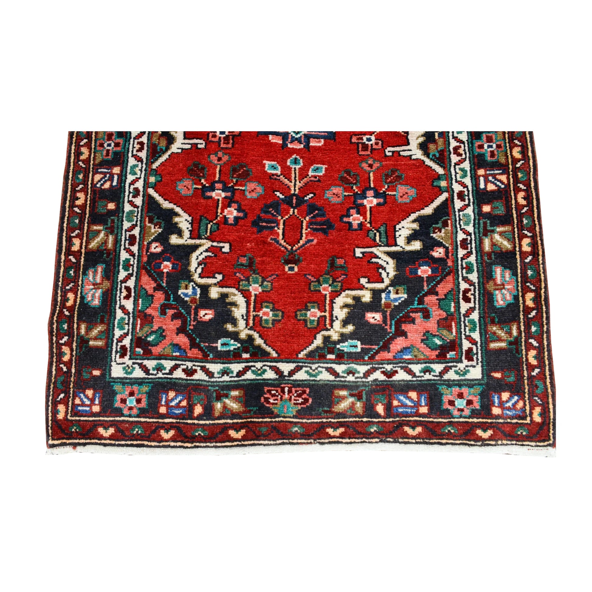 End detail of Persian Hamadan runner showing a floral medallion, branching motifs, layered borders and fringe