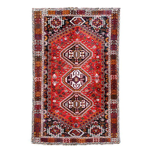 Full view of Persian Shiraz hand-knotted wool rug with rich red field, three geometric medallions and layered borders, 252 x 160 cm