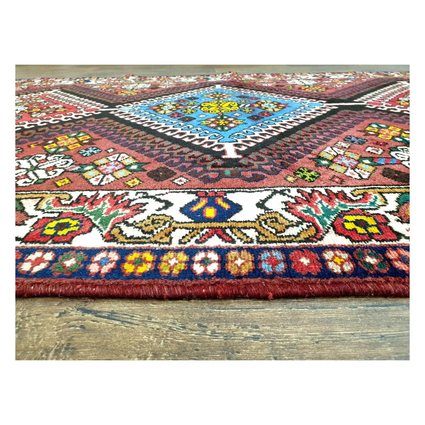 Blue diamond medallion and border detail on Persian Shiraz hand-knotted wool rug