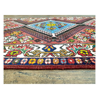 Blue diamond medallion and border detail on Persian Shiraz hand-knotted wool rug