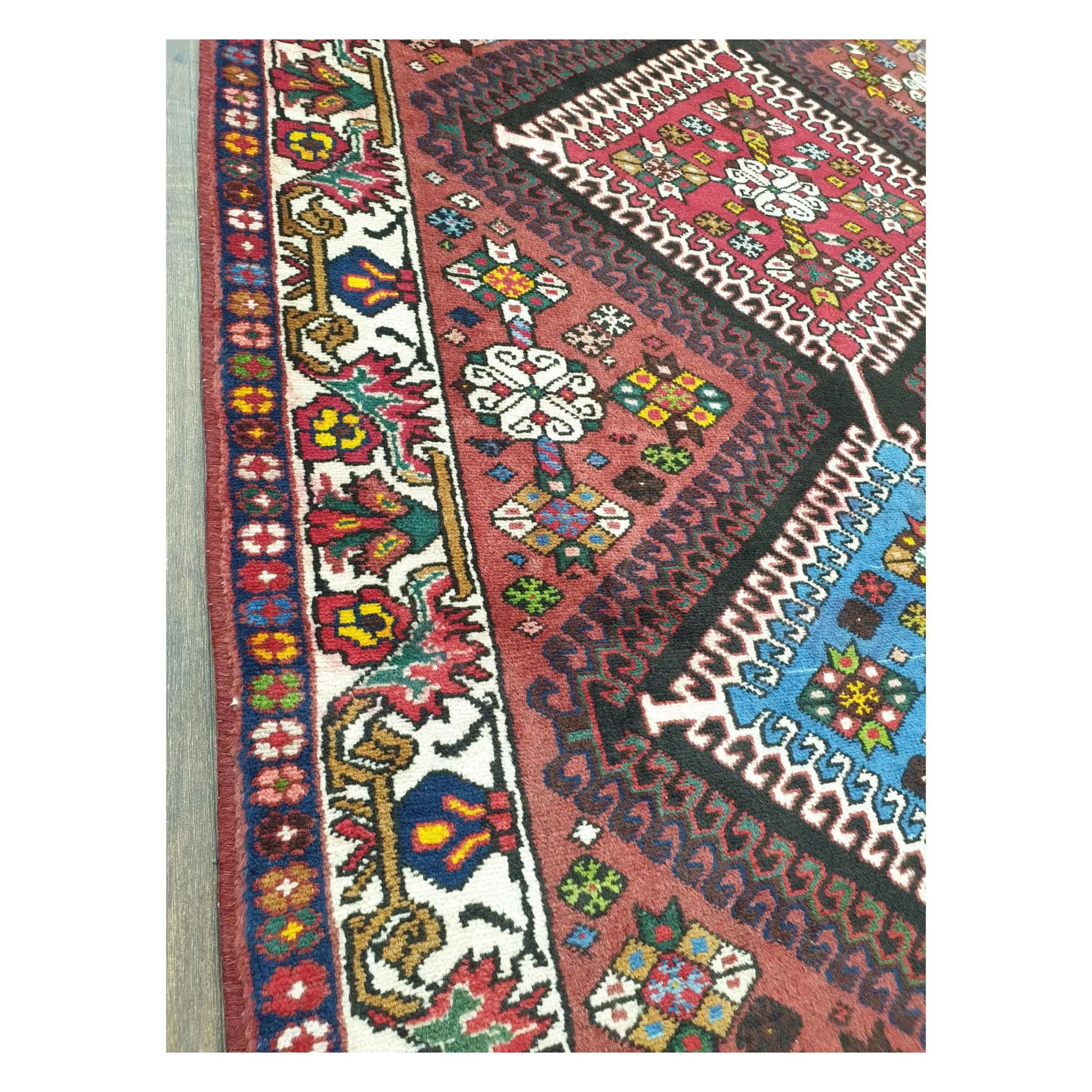 Field and side border detail of Persian Shiraz rug with geometric tribal motifs
