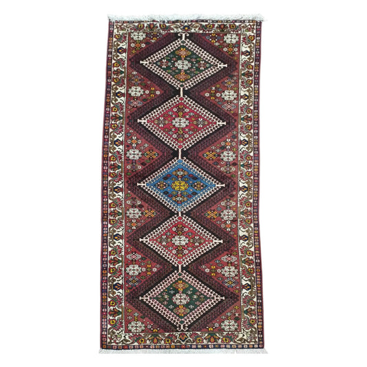 Full view of Persian Shiraz hand-knotted wool rug 302 x 125 cm with stacked diamond medallions
