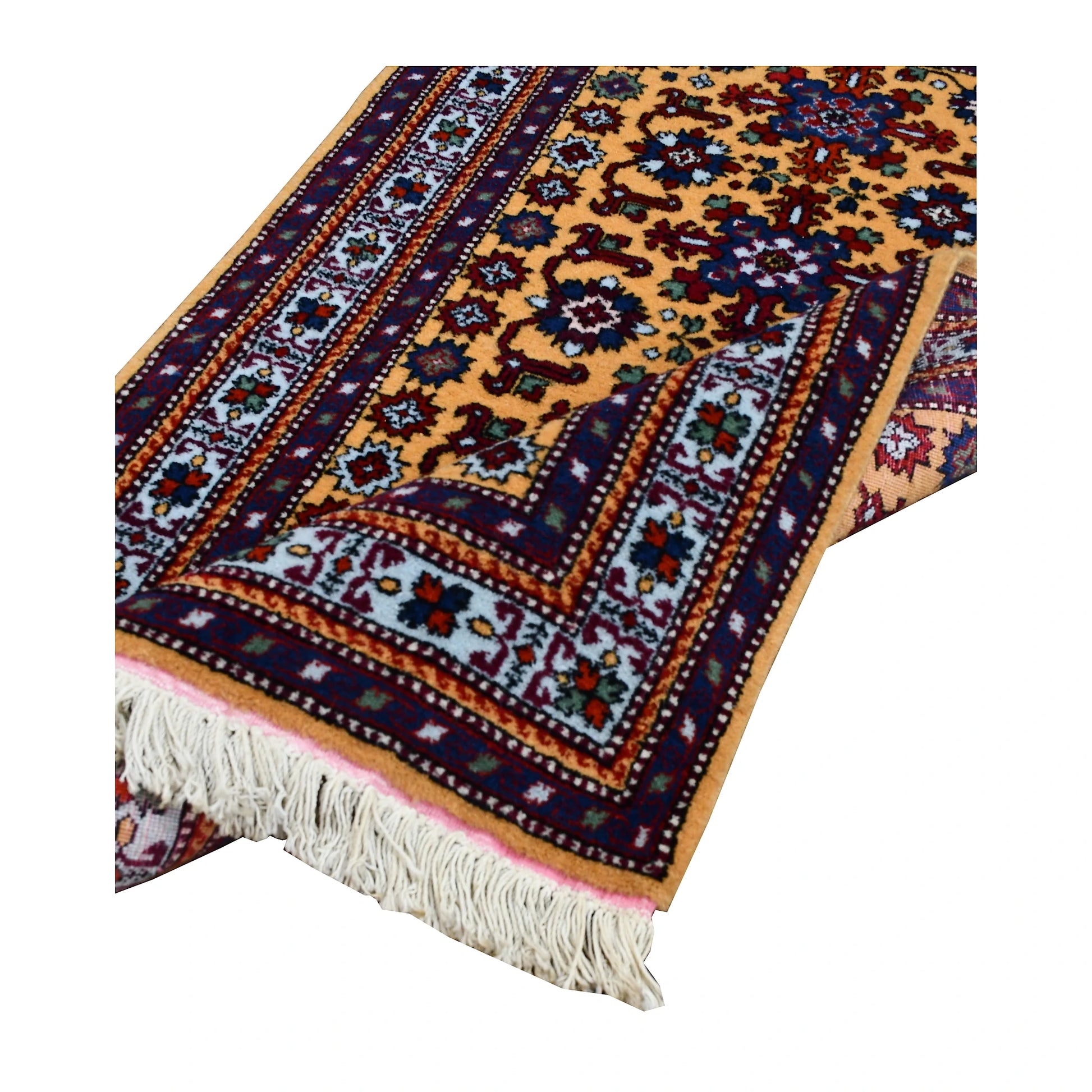 Angled end detail of Persian Veramin rug showing the wool pile, layered patterned borders and ivory fringe