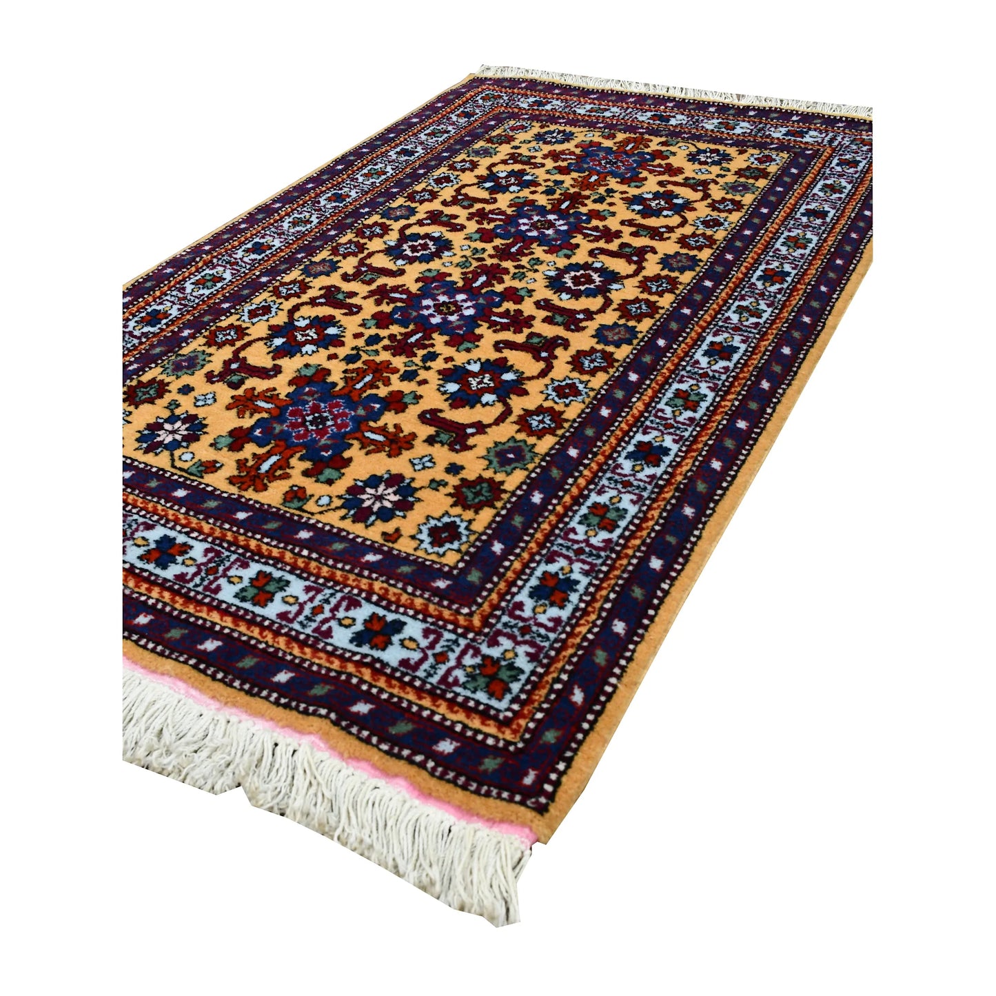 Angled full view of Persian Veramin rug showing the repeating floral lattice, layered borders and ivory fringe