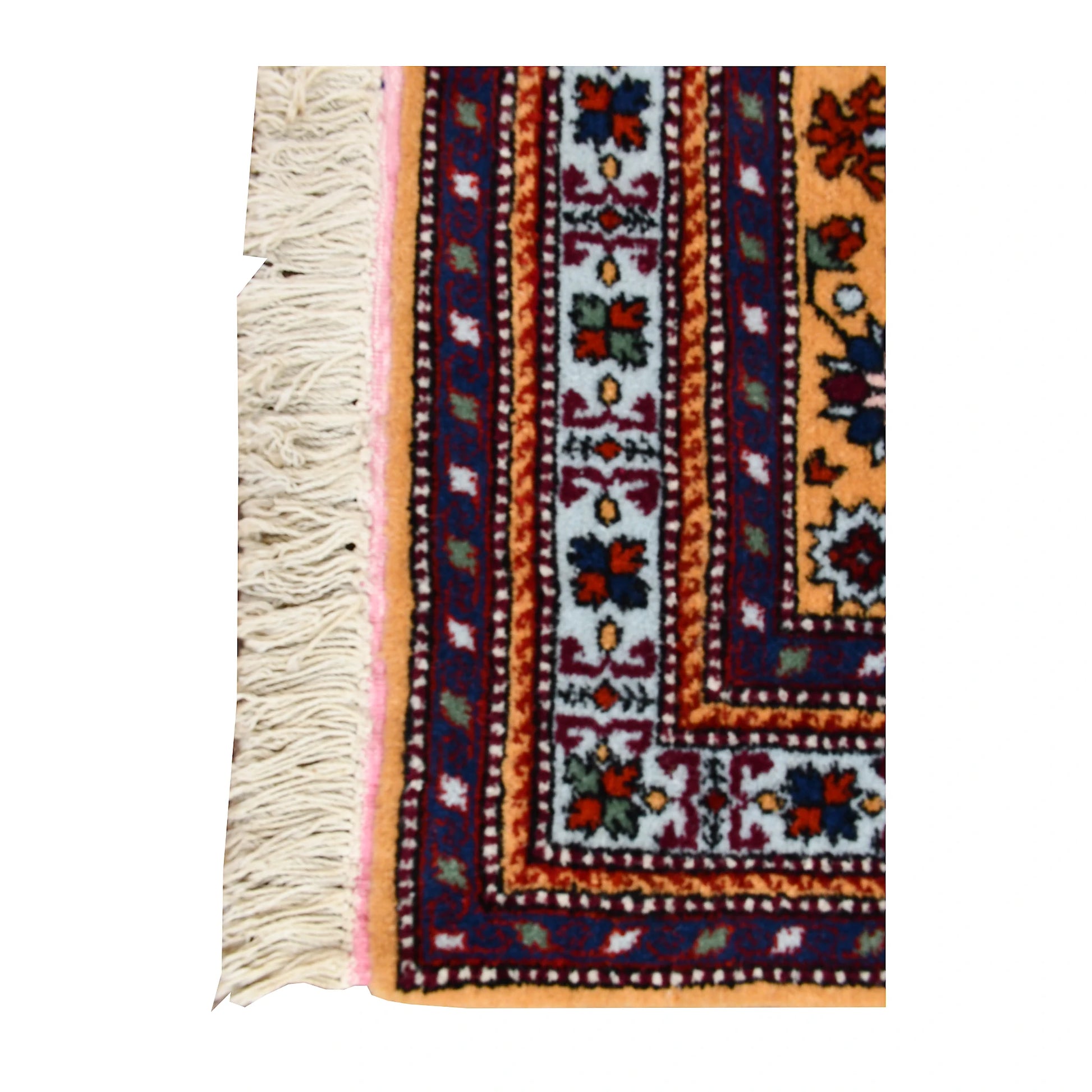 Corner detail of Persian Veramin rug showing the blue floral guard border, deep red edging and ivory fringe