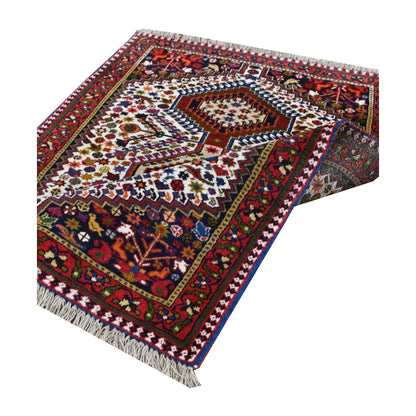 Angled full view of Persian Yalameh rug showing three aligned medallions and patterned borders
