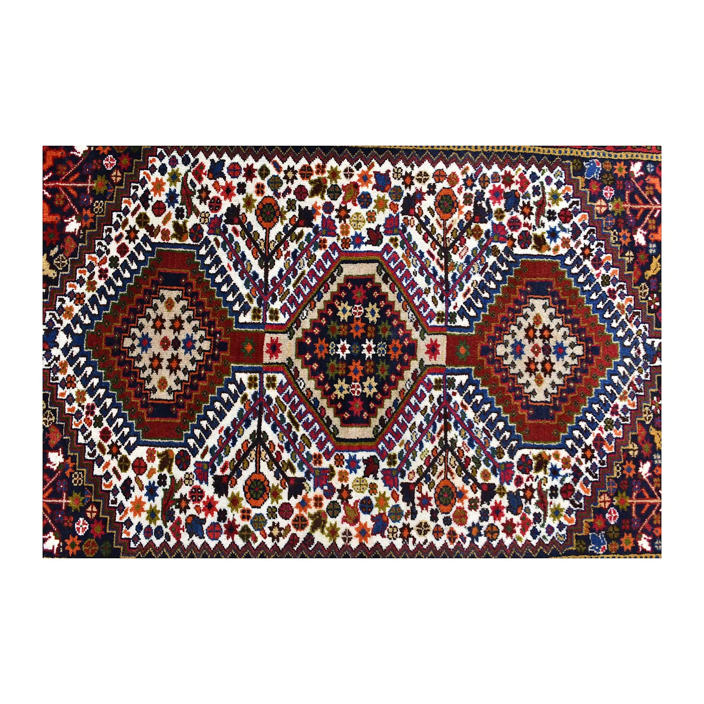 Field detail of Persian Yalameh rug showing three geometric diamond medallions surrounded by small motifs
