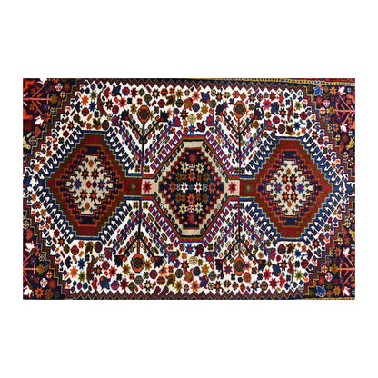 Field detail of Persian Yalameh rug showing three geometric diamond medallions surrounded by small motifs