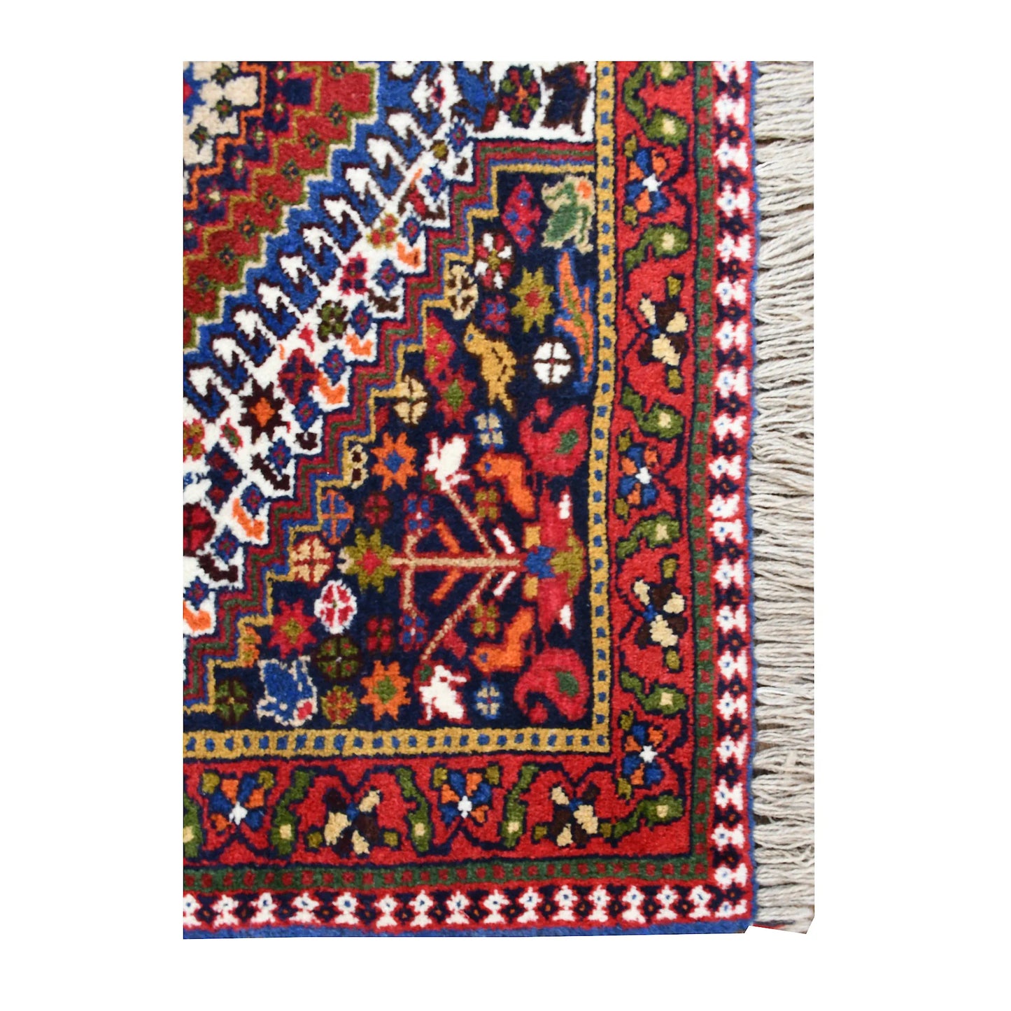 Corner detail of Persian Yalameh rug showing stylised animal and plant motifs beside the layered border