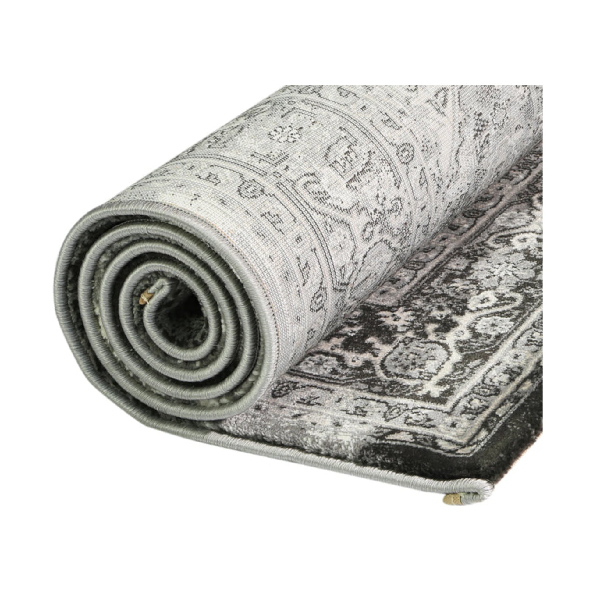 Rolled edge detail of Prague Teresa Charcoal traditional rug showing backing, binding and patterned polypropylene pile, 170 x 120 cm