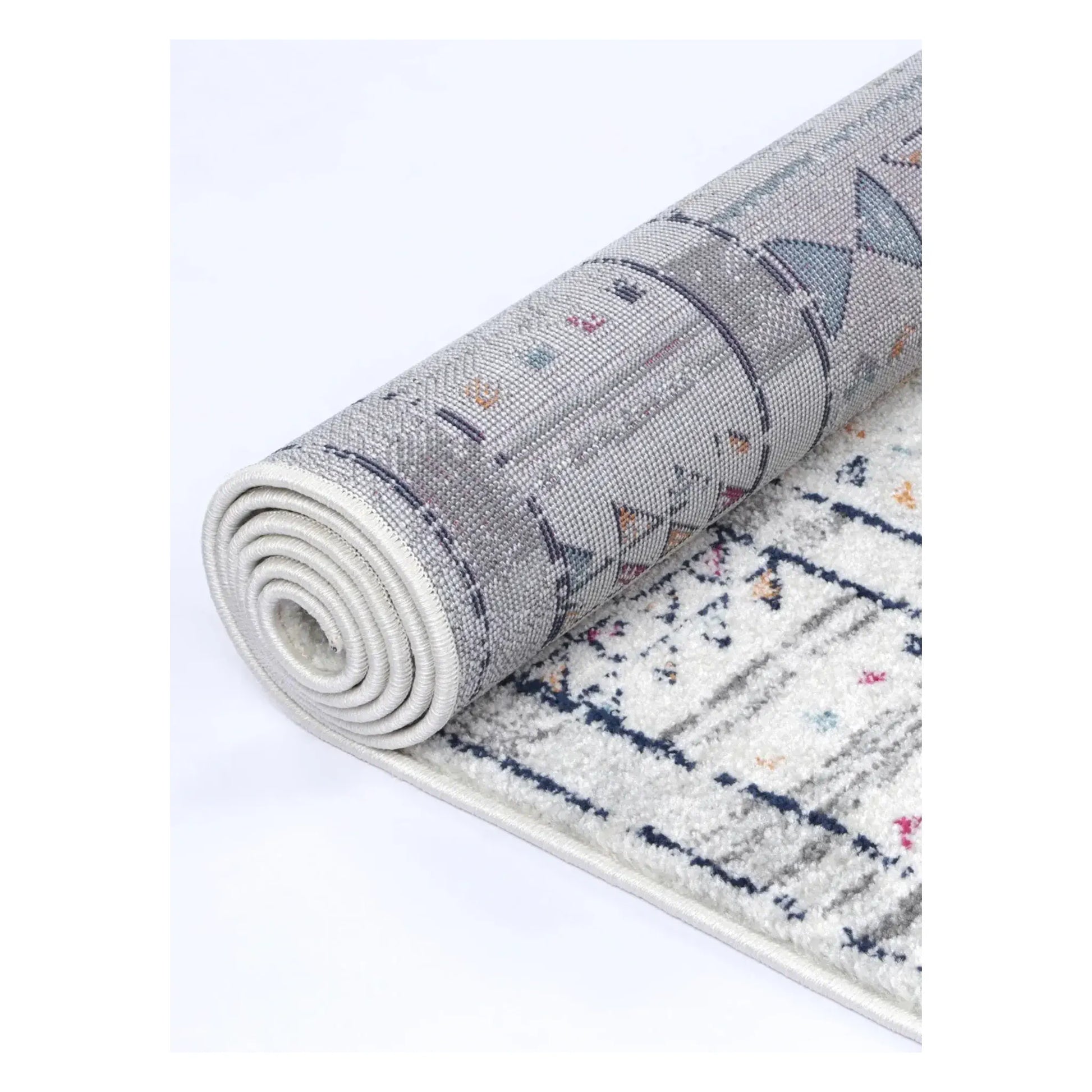 Rolled Provence grey pink rug showing flexible edge and polypropylene pile