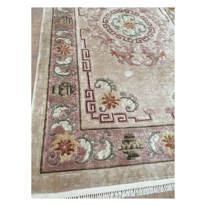 Border and corner detail of vintage Chinese silk rug with floral and geometric motifs