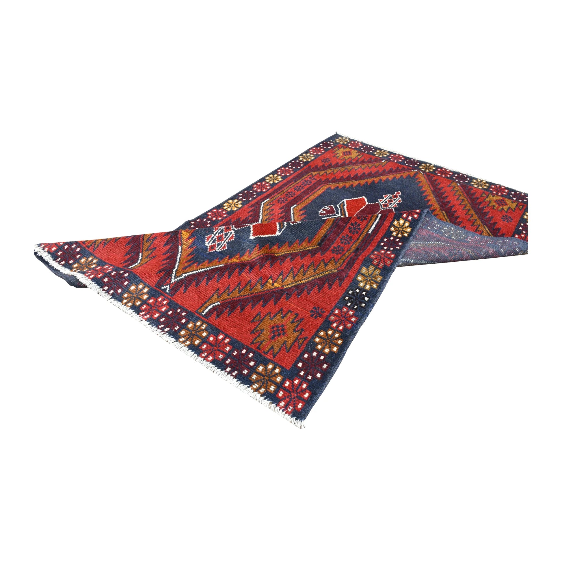 Folded view of Afghan Baluchi hand-knotted wool rug showing its patterned pile, border and fringe