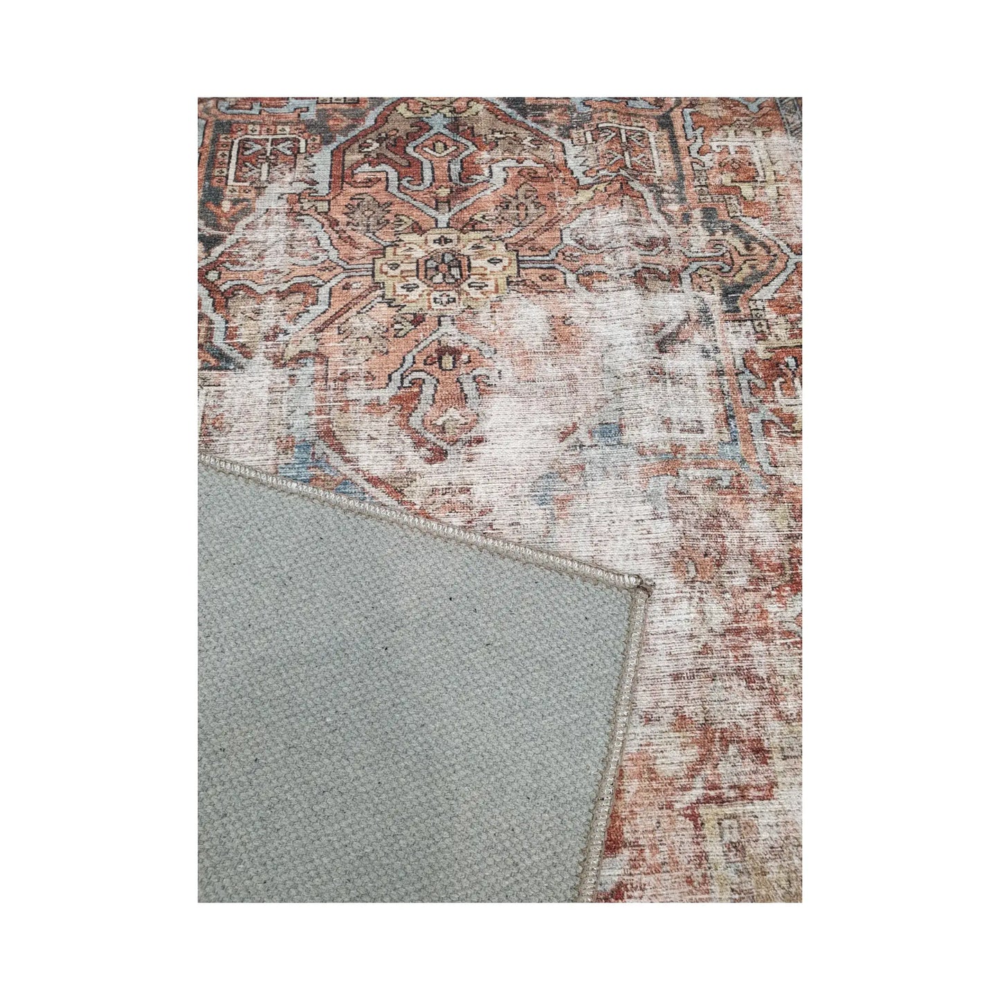 Close-up of rust blue cotton rug corner with back and edge detail