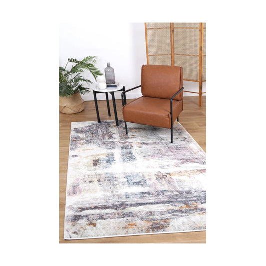 Styled room view of Santa Fe Verada Abstract Rug with modern chair, timber screen and neutral interior setting