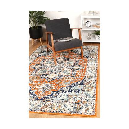 Sicily Messina Orange and Blue transitional rug styled with chair and indoor décor, showing colourful distressed design, 290 x 200 cm