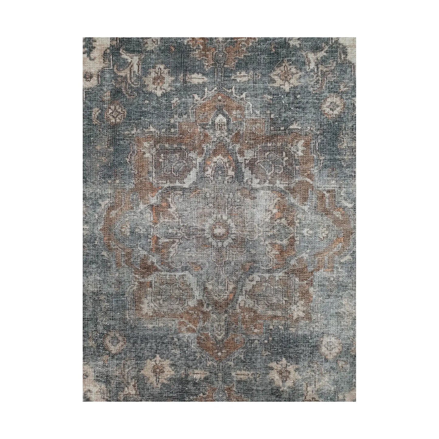 Close-up of slate blue rust cotton rug central medallion and faded floral pattern