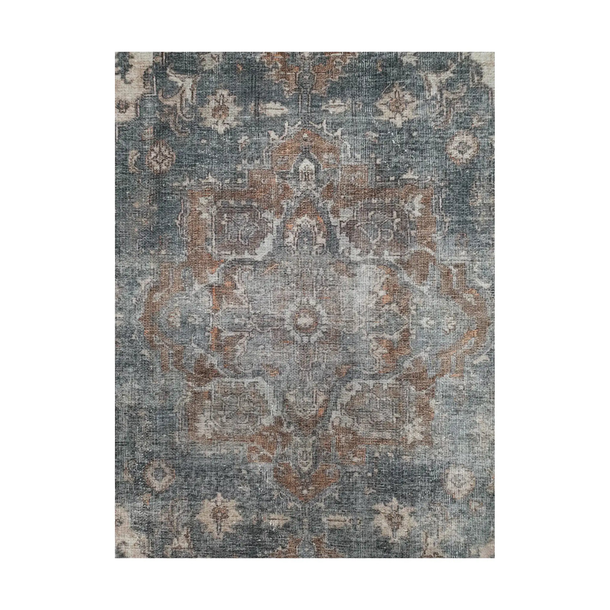 Close-up of slate blue rust cotton rug central medallion and faded floral pattern