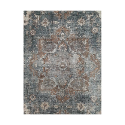 Close-up of slate blue rust cotton rug central medallion and faded floral pattern