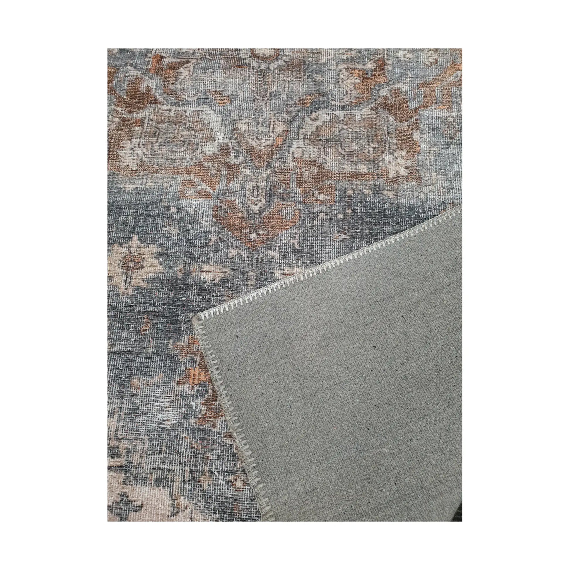 Close-up of slate blue rust cotton rug corner with back and edge detail