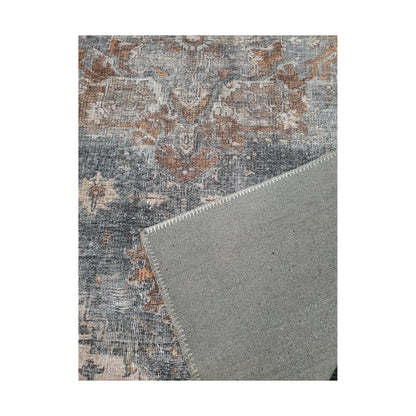 Close-up of slate blue rust cotton rug corner with back and edge detail