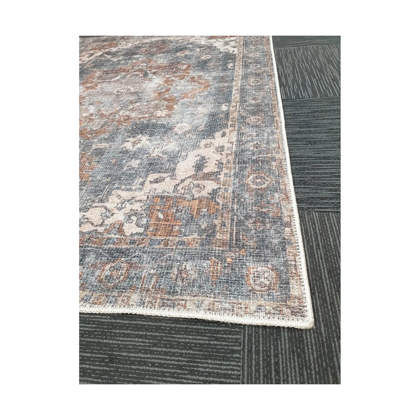 Close-up of slate blue rust cotton rug corner with ornamental border detail