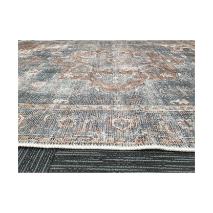 Low-angle close-up of slate blue rust cotton rug edge and woven surface texture