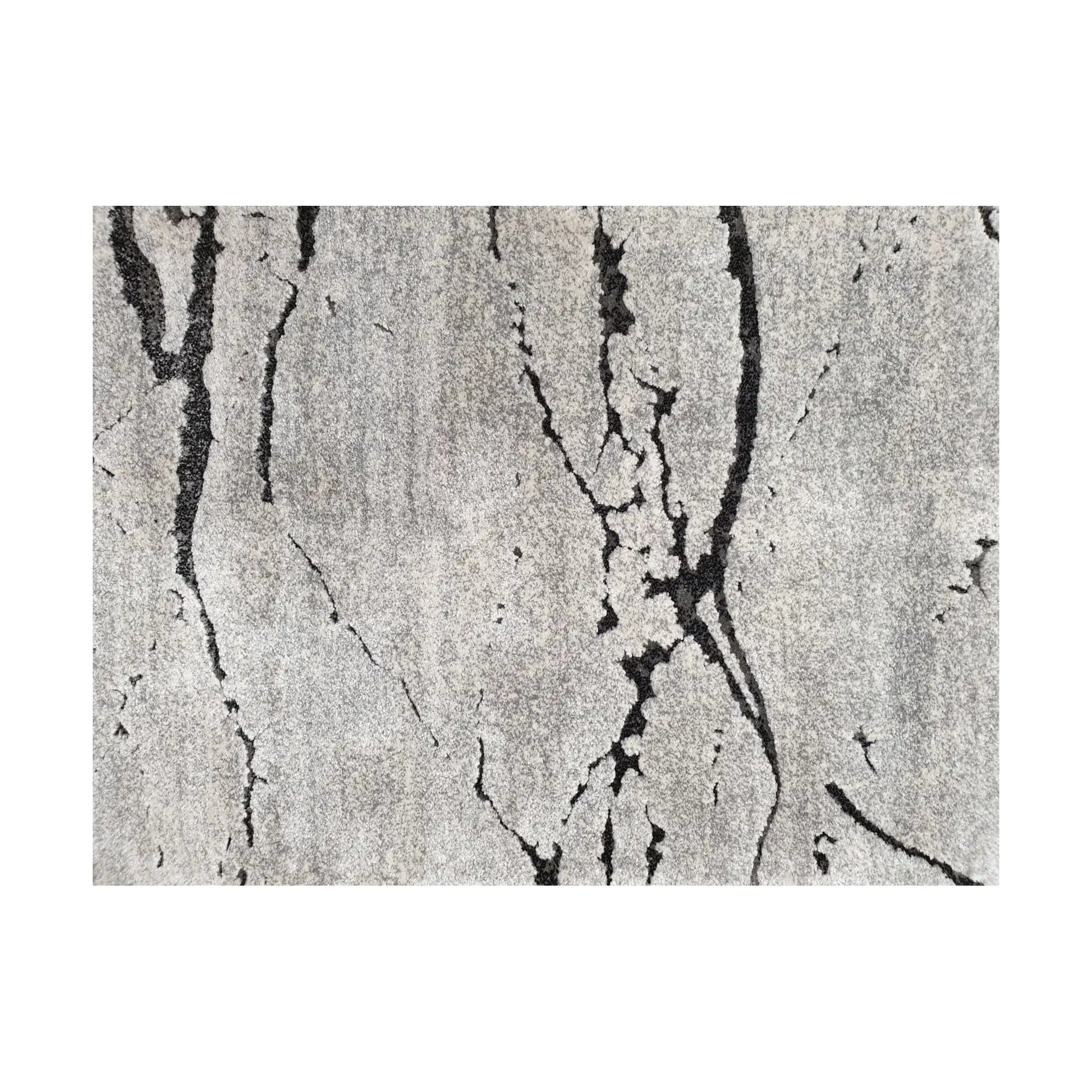 Close-up detail of Stella Grey Runner Rug showing irregular black linear markings on grey textured surface