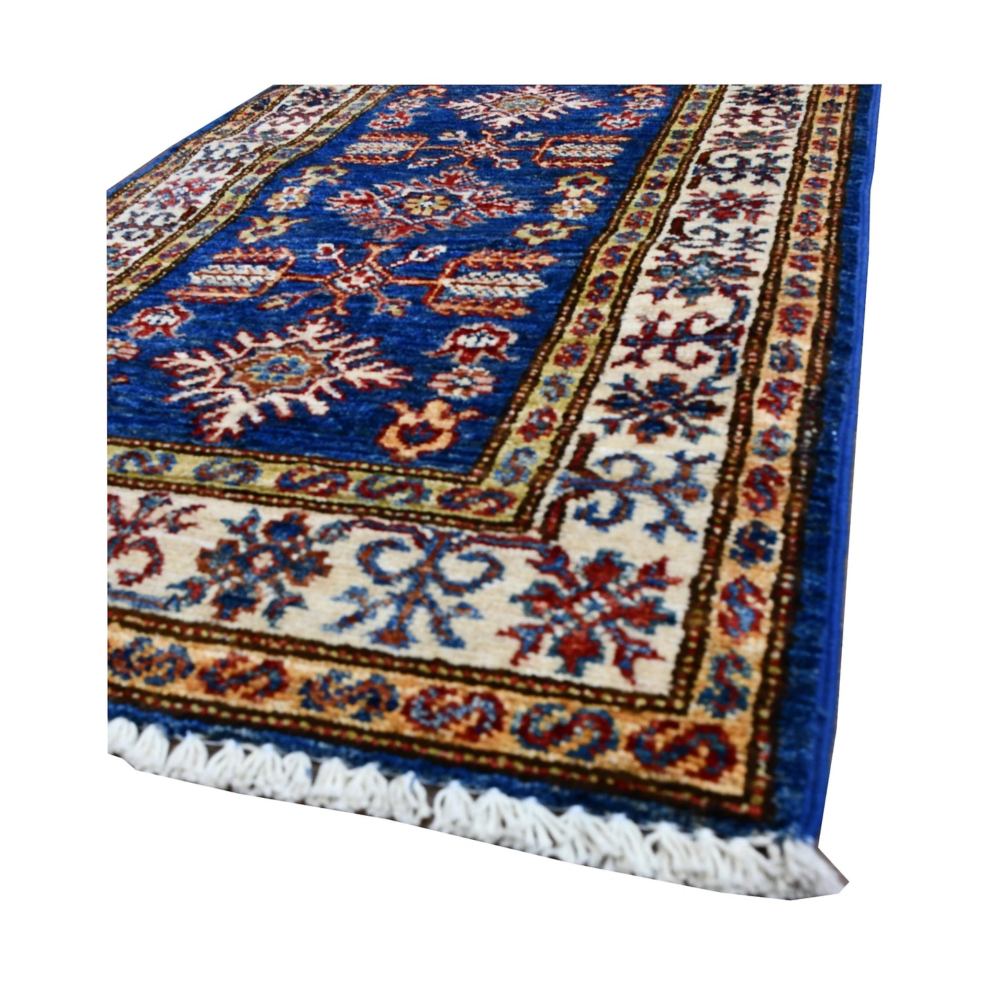 Angled border and fringe detail of Super Kazak rug showing blue field, ivory border and wool texture