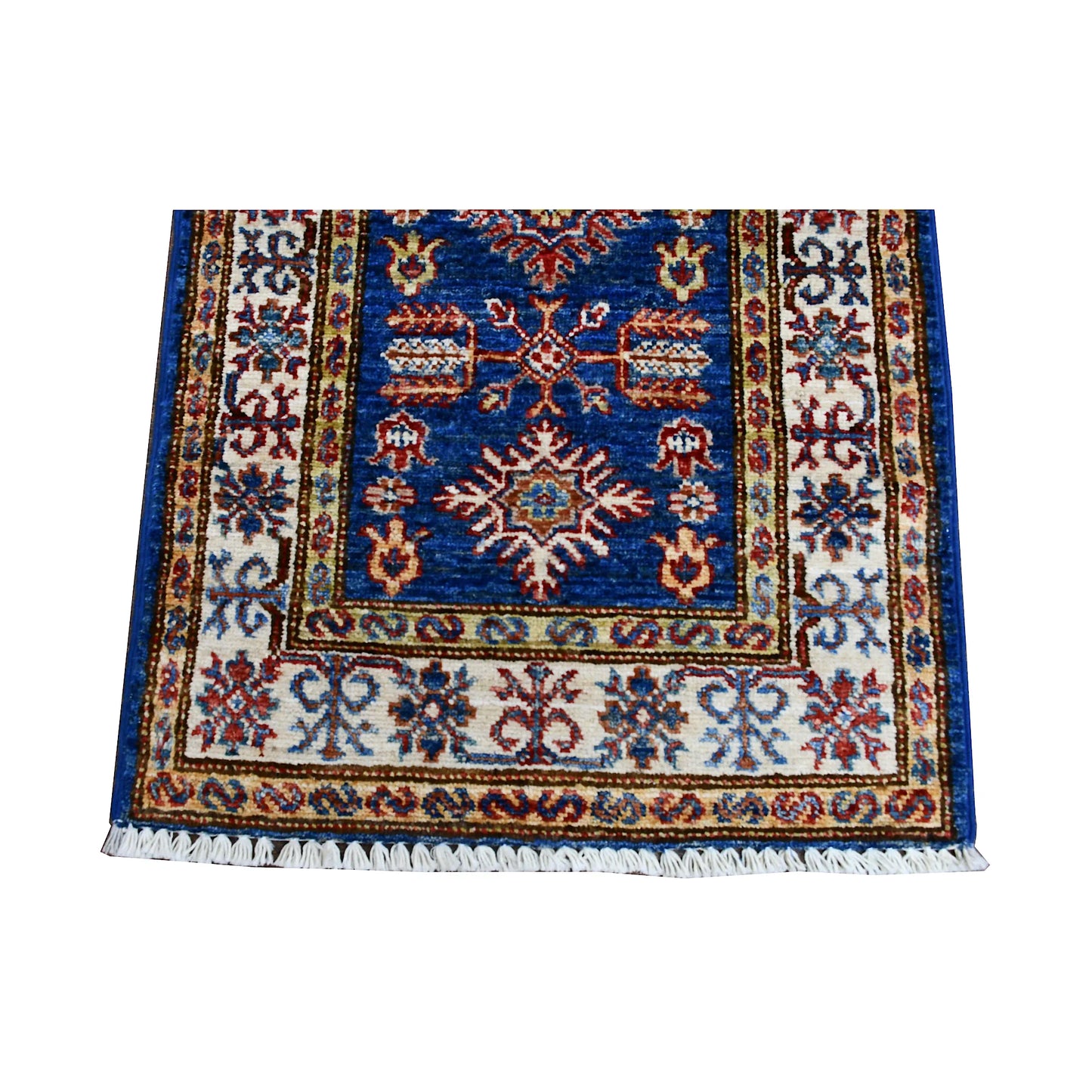 End field and fringe detail of Super Kazak rug with blue medallion field and decorative ivory border
