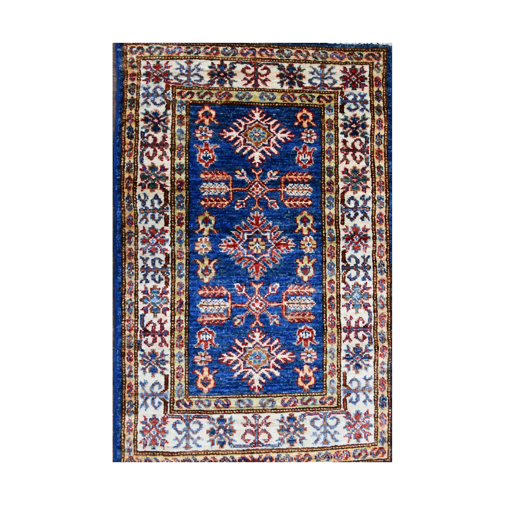 Top view of Super Kazak rug with blue centre, ivory border and red multicolour geometric motifs
