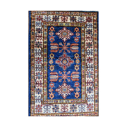 Top view of Super Kazak rug with blue centre, ivory border and red multicolour geometric motifs